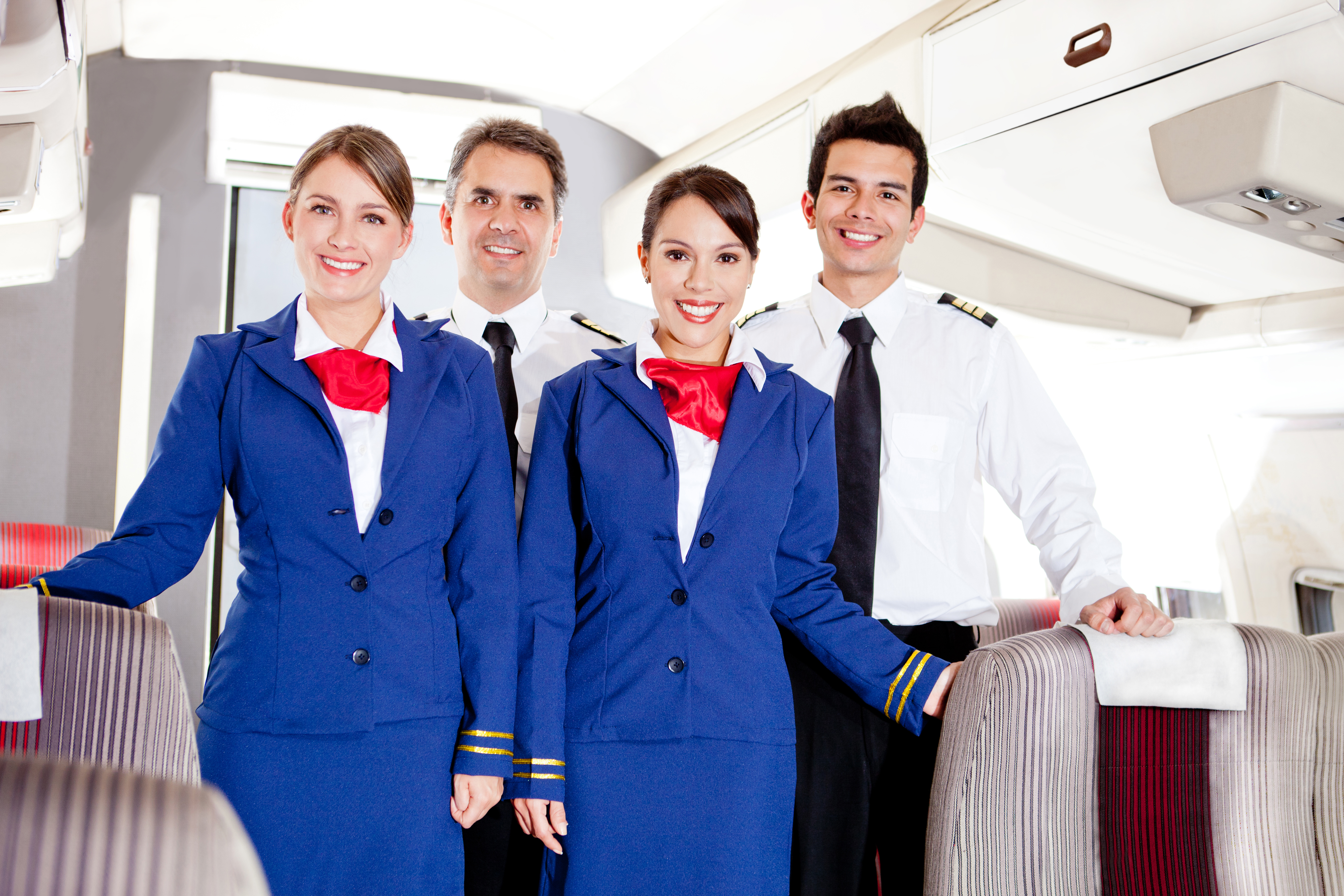 Friendly cabin crew in an airplane smiling