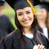 graduation woman portrait smiling and looking happy outdoors